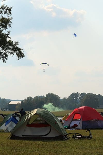 BRAG Cyclists Camp and Watch Skyjumpers parachute down during the USBR 21 Ride at camp at Spaceland Atlanta skydiving